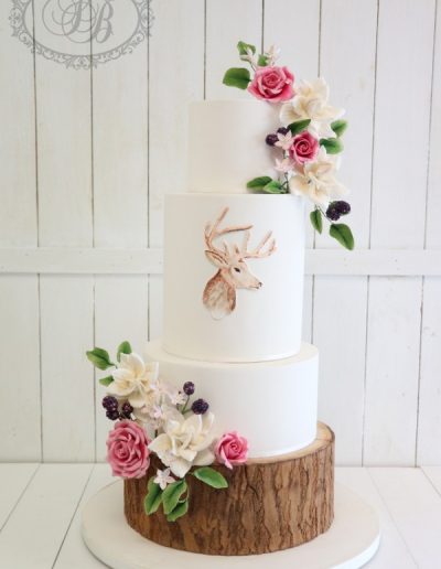 Wooden log and stag wedding cake with sugar flowers and blackberries