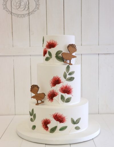 Piped pohutakawha and wooden fantail wedding cake