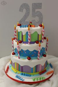 Colourful 25th celebration cake with candles & cherries