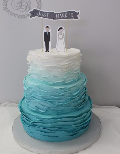 Blue ombre ruffles with paper figure topper