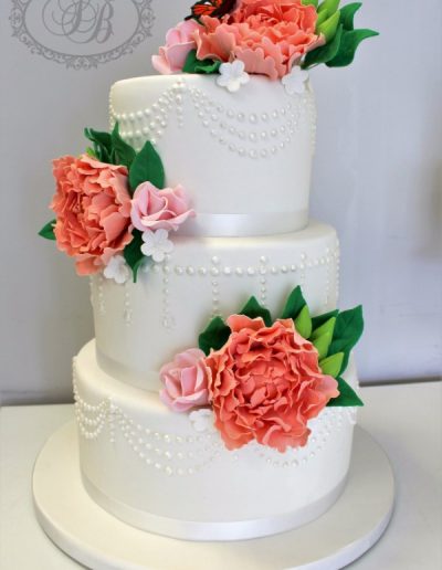 Pearl piped ivory wedding cake with peonies and butterfly