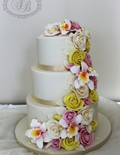 Ivory and champagne 3 tier wedding cake with flower cascade