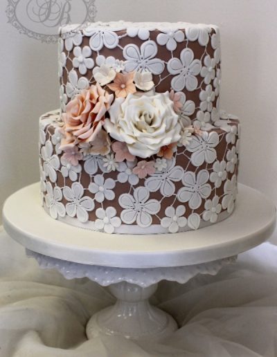 Mauve wedding cake with sugar applique lace and roses