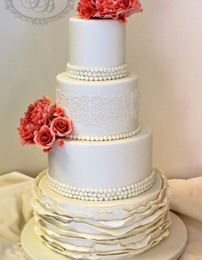 4 tier wedding cake with ruffles and terracotta sugar flowers