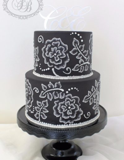 Black wedding cake with white embroidery piped flowers