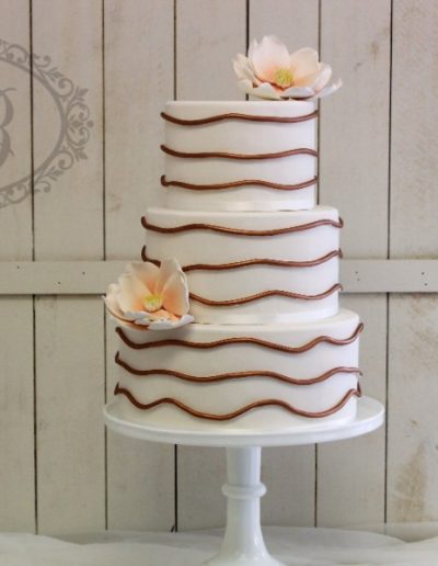 Copper strand wedding cake with peach sugar magnolias