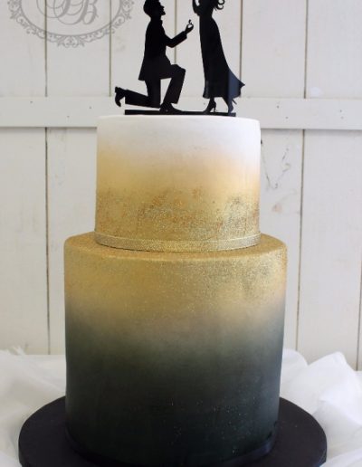 Airbrushed black and gold fade wedding cake with silhouette topper