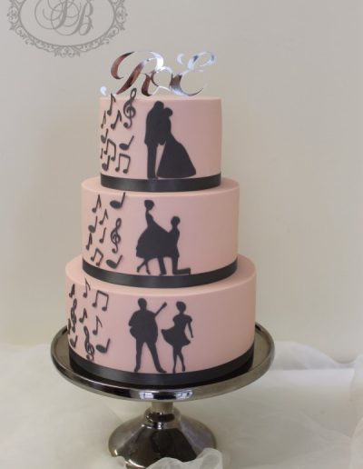 pink 3 tier wedding cake with musical silhouettes