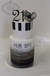 2 tier black watercolour and piano feature cake