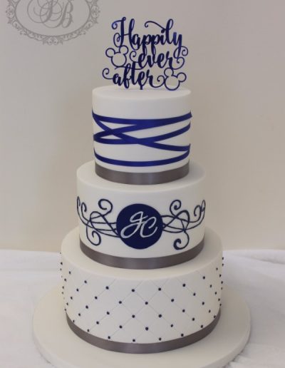 Royal blue and silver themed wedding cake with disney topper
