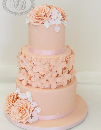 3 tier peach wedding cake with sugar flowers