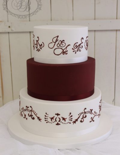 Maroon and white piped wedding cake