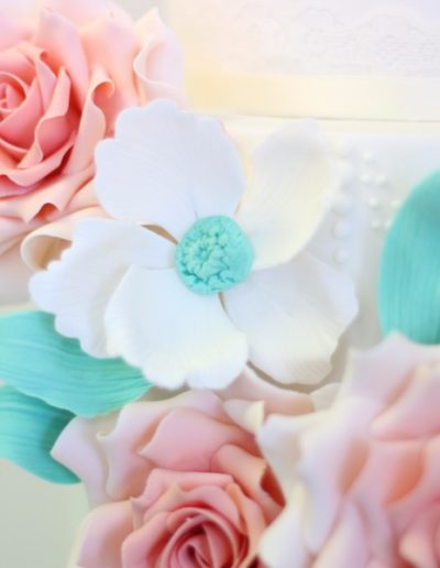 Teal and peach sugar flowers close up