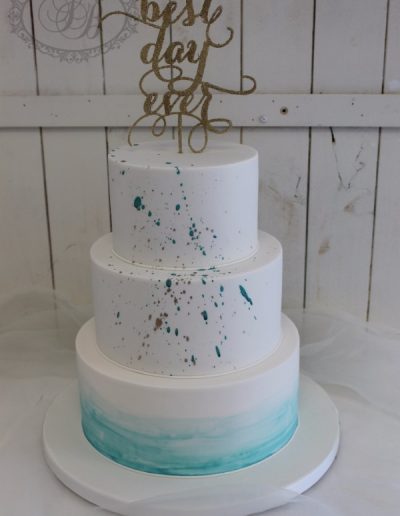 Teal paint splatter and watercolour wedding cake