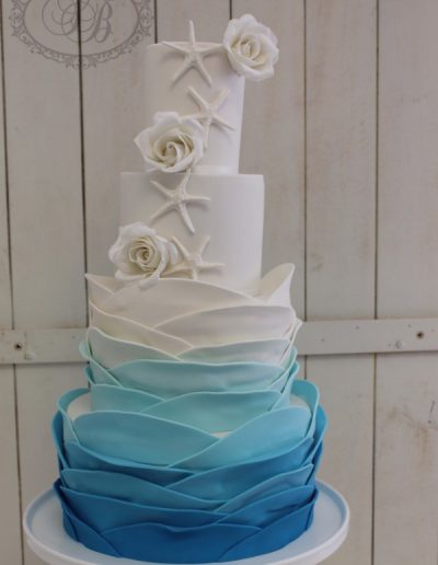 Ombre wave ruffles with sugar flowers and starfish