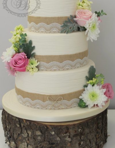 3 tier scribed ivory fondant wedding cake with lace, hessian and fresh flowers wedding cake