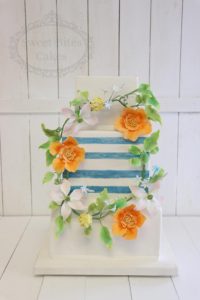 Floral wreath and blue stripes wedding cake