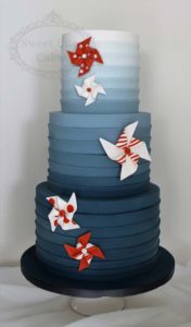 Navy ombre wedding cake with orange fans