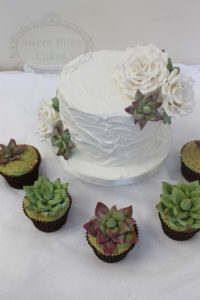 Royal iced wedding cake with succulents cupcakes