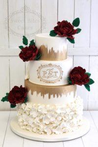 4 tier wedding cake with blossom ruffles and red peonies