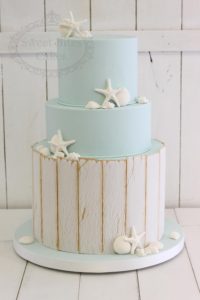 Beach themed wedding cake with seashells