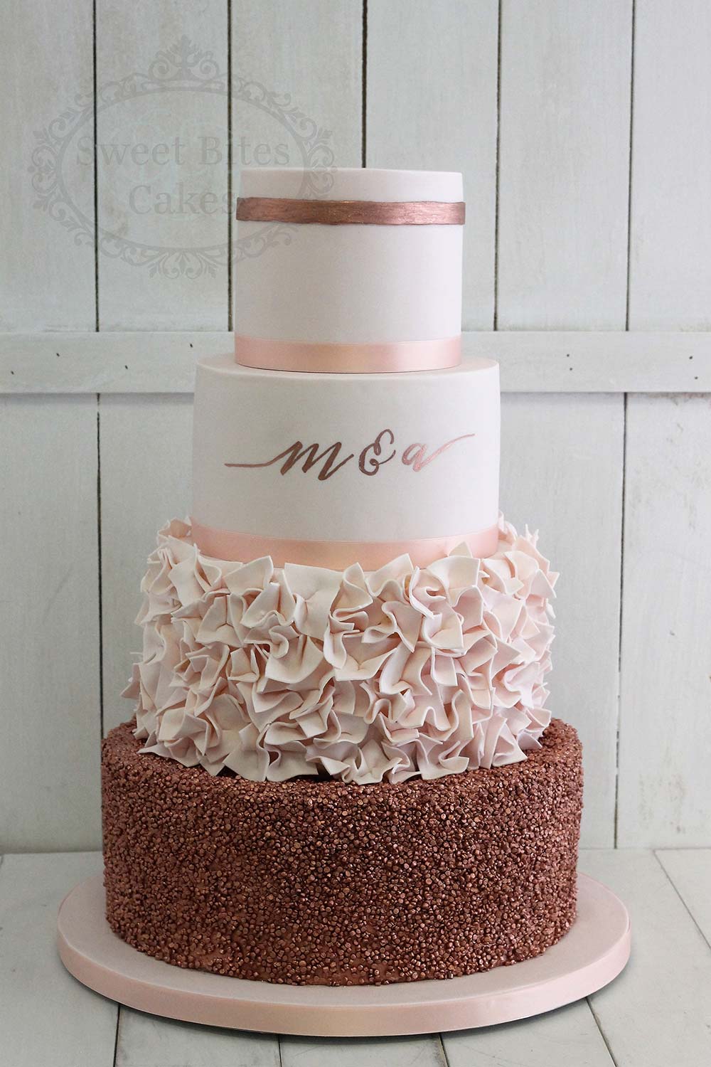 Pink and rose  gold  wedding  cake  with sequins and ruffles 