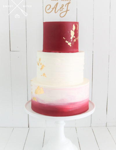 wedding cake on stand red burgundy ombre gold