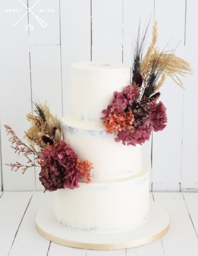 semi naked 3 tier wedding cake dried flowers beach