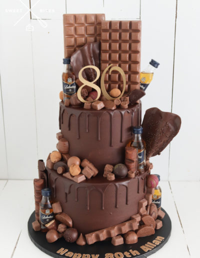2 tier chocolate drip cake overload mini alcohol bottles choc blocks sails assorted mixed chocolates